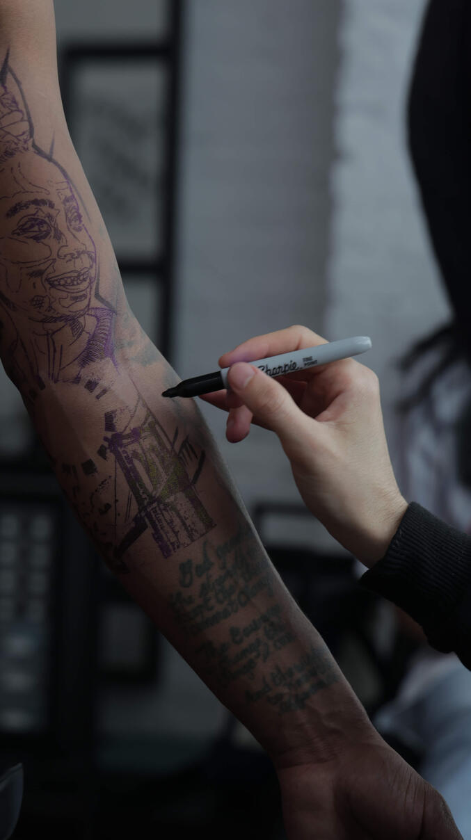 Tattooer Igor Vtoroff drawing custom freehand design.